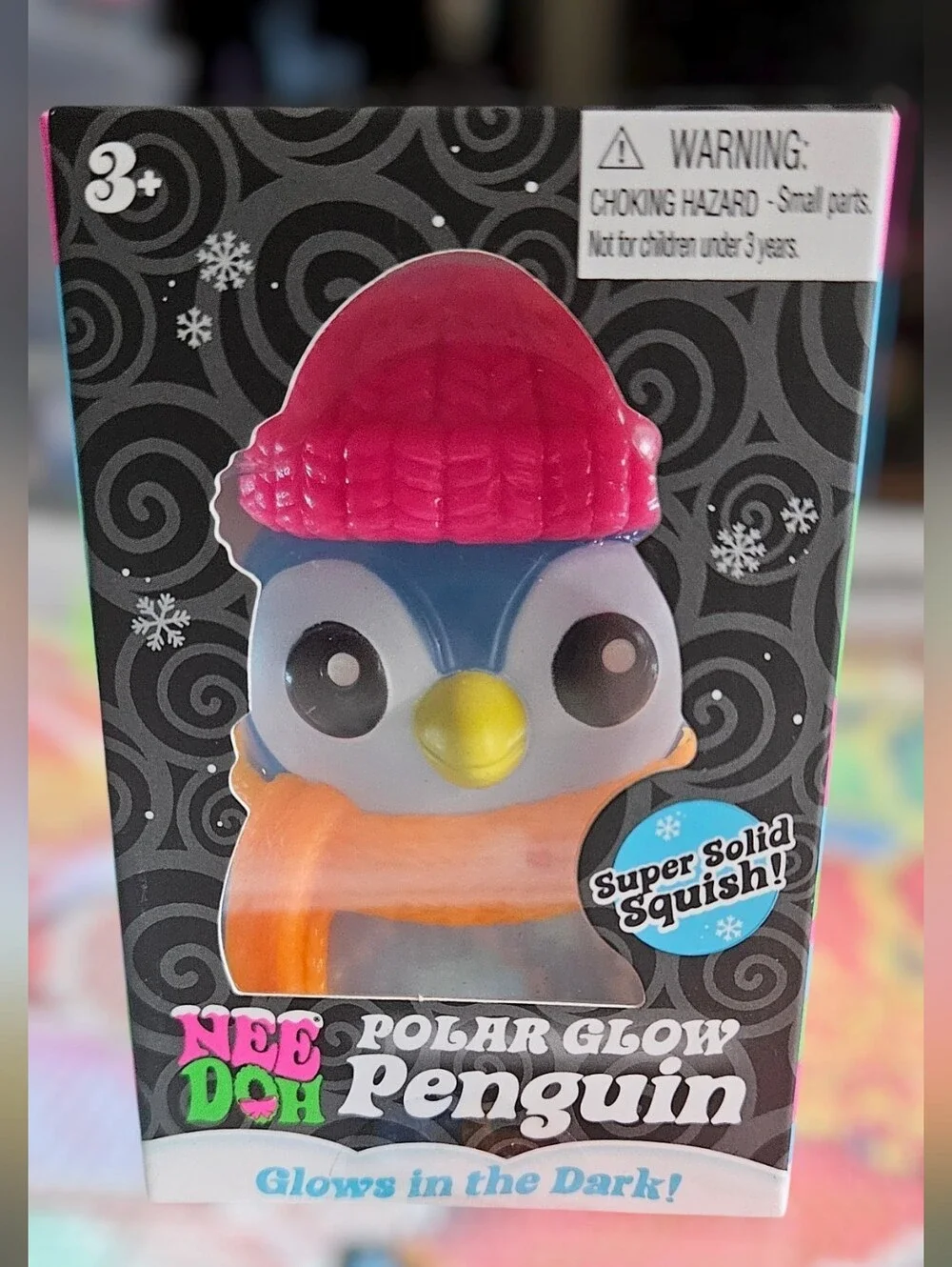 NeeDoh Polar Glow Penguin Squishy Toy - Blue Body, Pink Hat, Orange Scarf